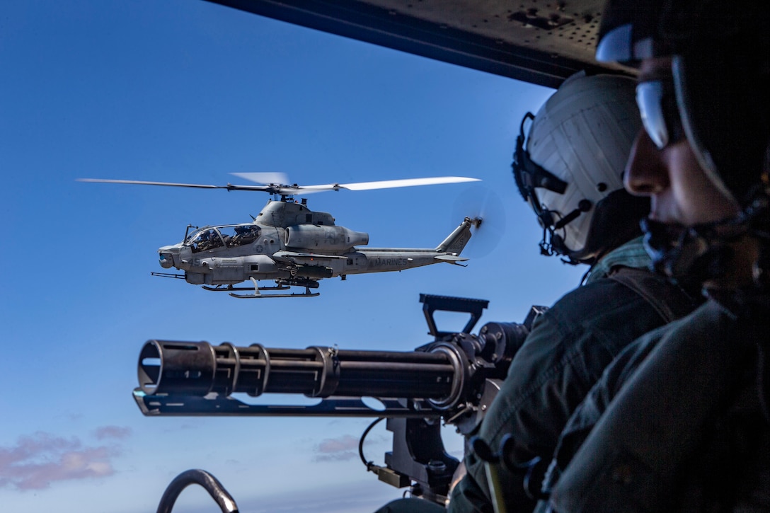 An AH-1Z Viper helicopter and a UH-1Y Venom helicopter, fly alongside each other during an aerial gunnery range at Naval Air Facility El Centro, California, July 16.