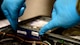 An Airmen removes hardware from a computer at Creech Air Force Base, Nevada.