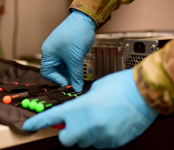 An Airmen grabs a screwdriver to remove hardware at Creech Air Force Base, Nevada.