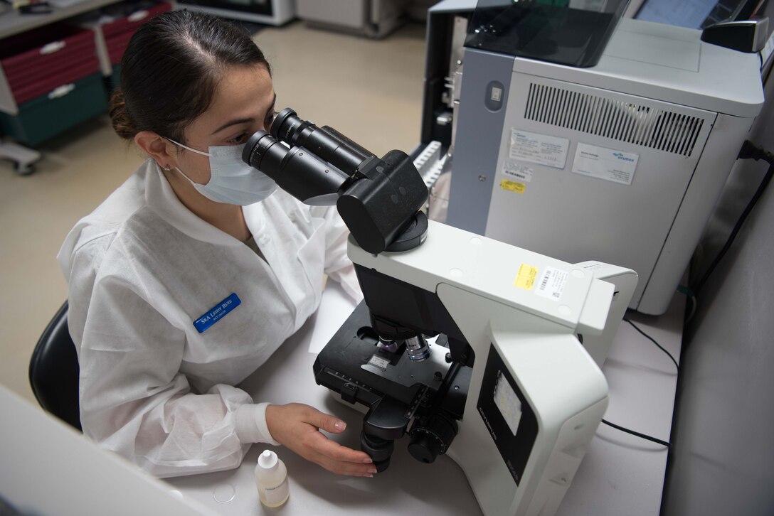 Senior Airman Leidy Ruiz, 22nd Medical Support Squadron lab technician, inspects a blood sample through a microscope July 20, 2020, at McConnell Air Force Base, Kansas. The lab has limited testing capabilities and outsources specific tests to properly-equipped medical facilities at Wright-Patterson AFB, Ohio and Wilford Hall at Lackland AFB, Texas. (U.S. Air Force photo by Senior Airman Alexi Bosarge)