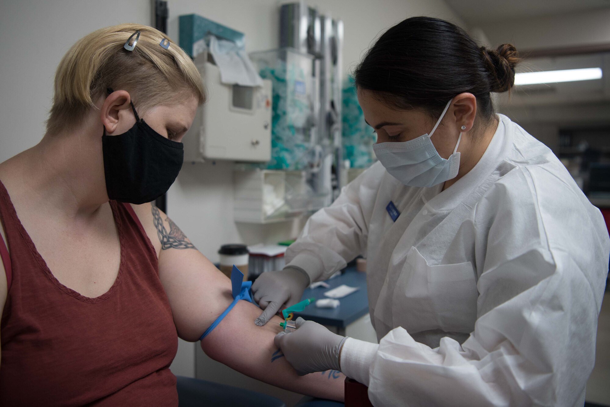 Senior Airman Leidy Ruiz, 22nd Medical Support Squadron lab technician, prepares to draw blood from Jamie Moulton July 20, 2020, at McConnell Air Force Base, Kansas. The lab services approximately 200 patients a week and provides a wide variety of tests for service members and their families. (U.S. Air Force photo by Senior Airman Alexi Bosarge)