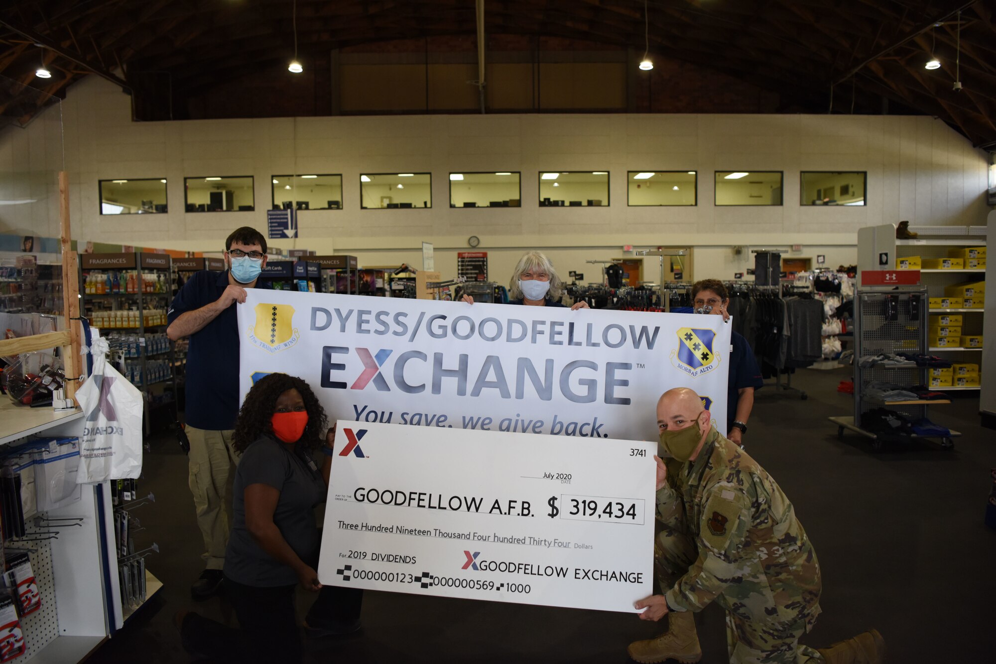 Base Exchange general manager Patricia Tinker presents U.S. Air Force Col. Andres Nazario, 17th Training Wing commander, with a check for $319,434 at the Goodfellow Exchange on Goodfellow Air Force Base, Texas, July 20, 2020. This check was a fraction of the $217 million dollars generated by AAFES in the 2019 fiscal year, split between the Air Force, Army, Navy, and Marine Corps bases that have an Exchange shopping center on them. (U.S. Air Force photo by Airman 1st Class Ethan Sherwood)