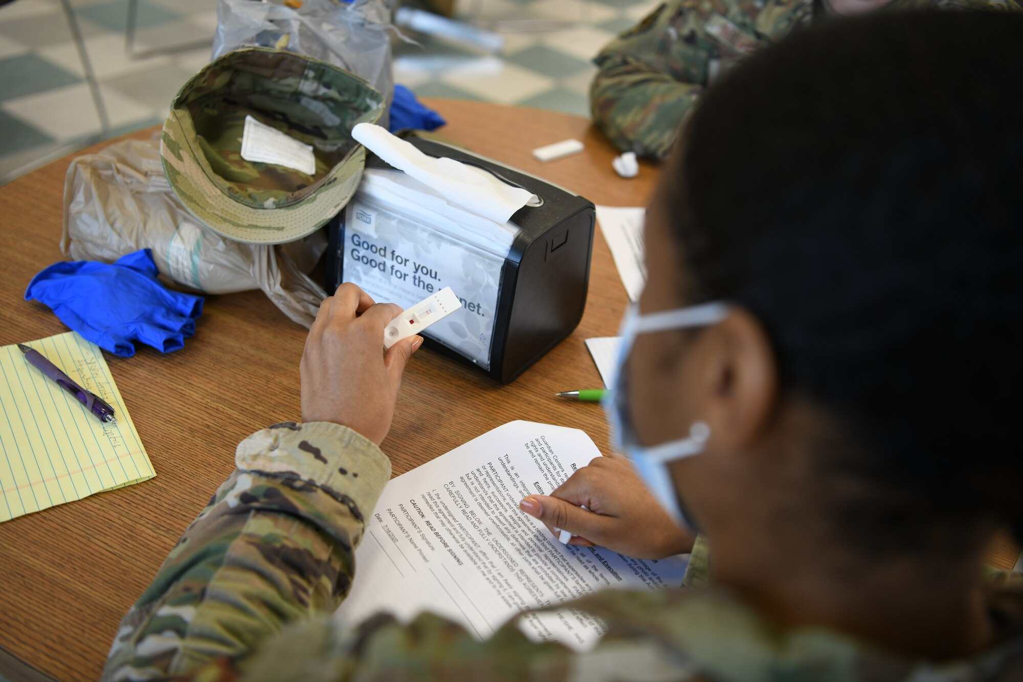 Photo shows a woman holding a test in her hand waiting on results.