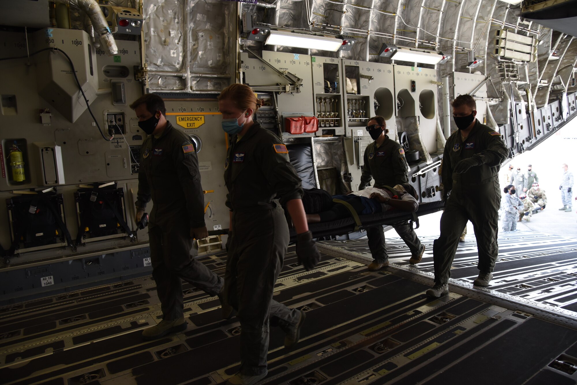 Reserve Citizen Airmen from the 36th Aeromedical Evacuation Squadron and Mississippi Air National Guardsmen from the 183rd AES work together loading patients into a C-17 Globemaster III during a three-day training event, July 20-22, 2020 at Keesler Air Force Base and the Mississippi Air National Guard's Combat Readiness Training Center in Gulfport, Mississippi. The training was a joint effort between Reservists and Guardsmen to work as one team, while training on patient care and handling during a simulated air evacuation of injured service members. (U.S. Air Force photo by Jessica L. Kendziorek)