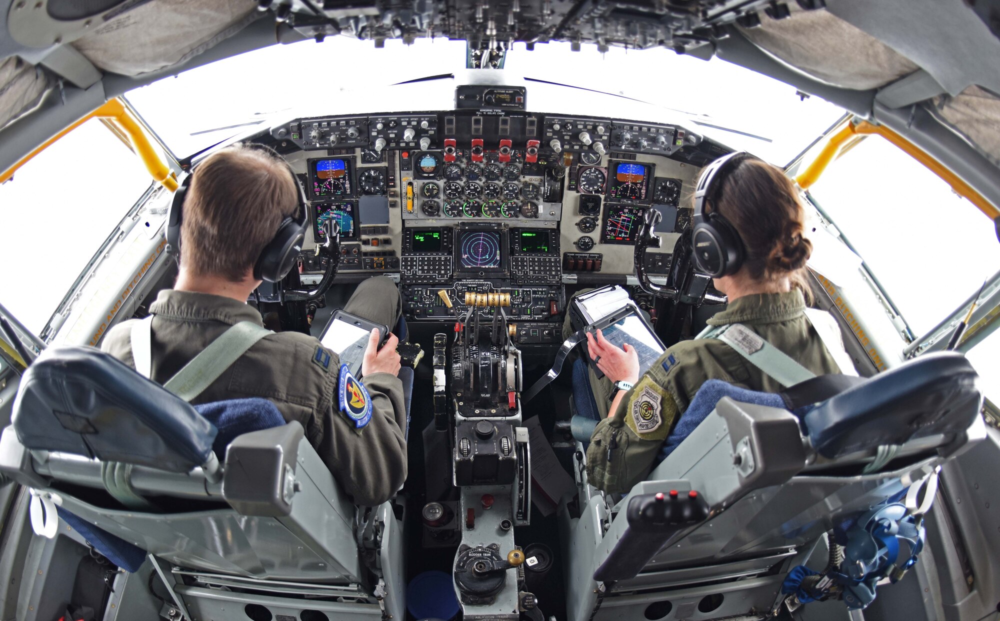 Captains Nicholas Boonstra, 351st Air Refueling Squadron pilot, left, and Marissa Hartoin, 351st ARS aircraft commander, review in-flight checklists over Scotland, July, 23, 2020. The 351st ARS, as part of the 100th Air Refueling Wing, conducts air refueling and combat support operations throughout the European and African area of responsibility. (U.S. Air Force photo by Senior Airman Brandon Esau)