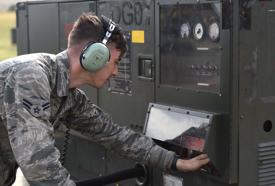 Airman 1st Class Cooper Murphy, 100th Aircraft Maintenance Squadron crew chief, turns on a power cart during pre-flight operations for a KC-135 Stratotanker at RAF Mildenhall, England, July, 23, 2020. The 100th Air Refueling Wing, conducts air refueling and combat support operations throughout the European and African area of responsibility. (U.S. Air Force photo by Senior Airman Brandon Esau)
