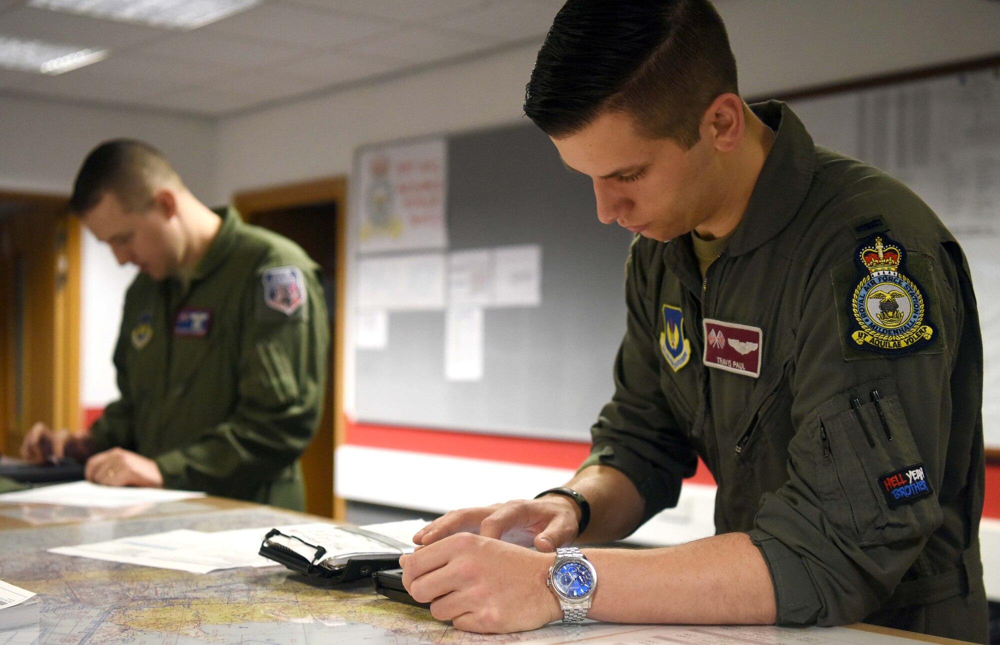 First Lieutenant Travis Paul, 351st Air Refueling Squadron pilot, right, and Tech. Sgt. Grant Ringenberg, 351st ARS boom operator, review flight plans at RAF Mildenhall, England, July 23, 2020. The 351st ARS provides operational air refueling, aeromedical evacuation, airlift and rapid contingency response options for U.S. and NATO fighter, bomber and support and reconnaissance aircraft in the European and African theater of operations. (U.S. Air Force photo by Senior Airman Brandon Esau)