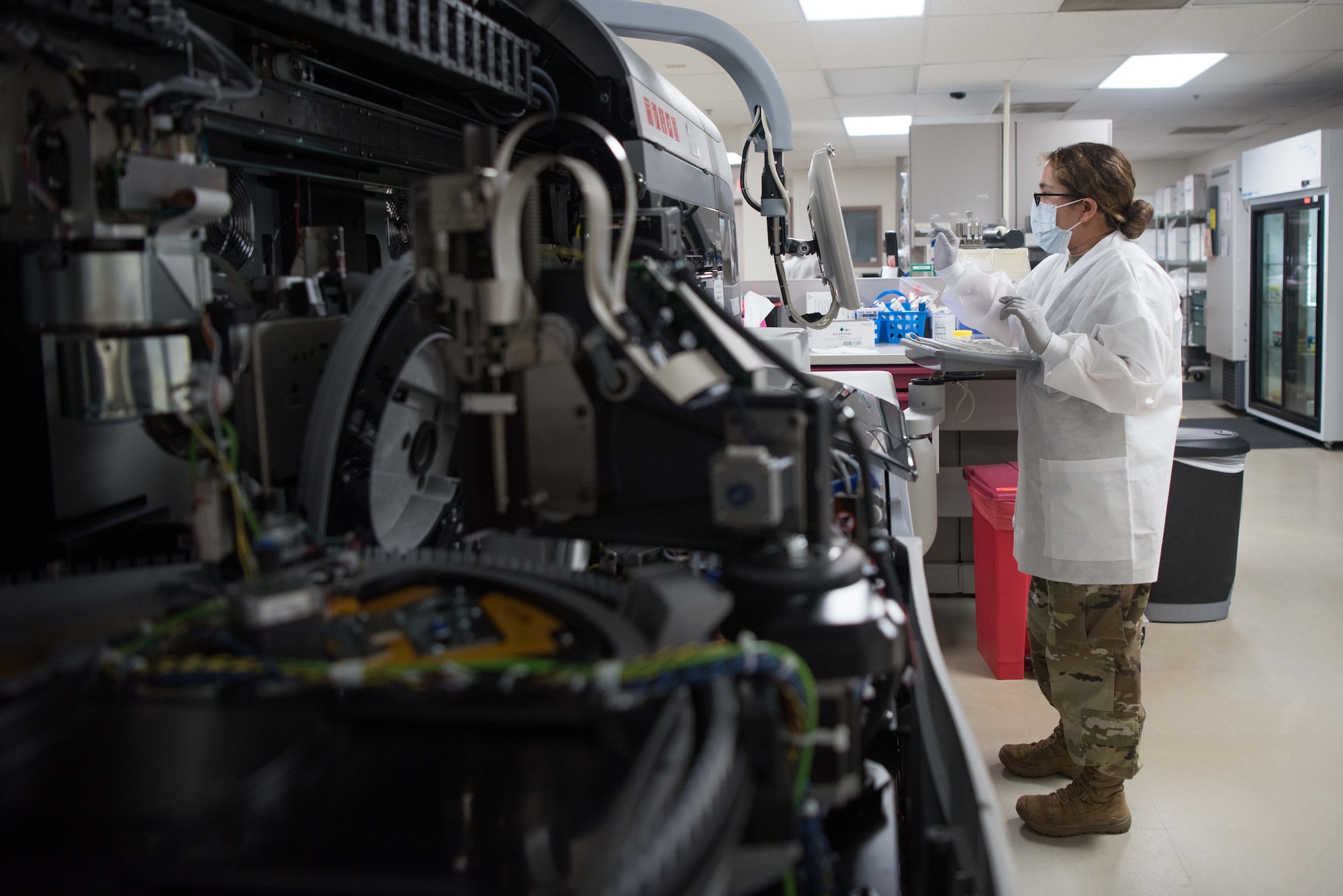 U.S. Air Force Staff Sgt. Maria Sibert, 22nd Medical Support Squadron lab technician, cleans a chemistry analyzer at McConnell Air Force Base, Kansas, July 20, 2020. The chemistry analyzer tests plasma samples for abnormalities such as high or low cholesterol, electrolytes, thyroid hormones and diabetes. (U.S. Air Force photo by Senior Airman Alexi Bosarge)