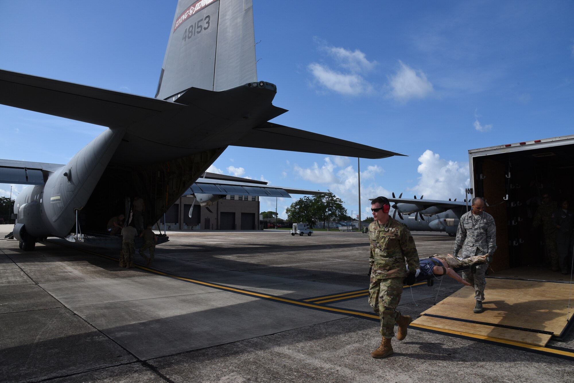 Airmen of the Air Force Reserve 36th Aeromedical Evacuation Squadron and Mississippi Air National Guardsmen from the 183rd AES transport a medical mannequin onto a C-130J Super Hercules aircraft as part of their three-day training event, July 20-22, 2020 at Keesler Air Force Base and the Mississippi Air National Guard's Combat Readiness Training Center in Gulfport, Mississippi. The purpose of the joint training event between Reservists and Guardsmen was to work as one team, while training on patient care and handling during a simulated air evacuation of injured service members. (U.S. Air Force photo by Jessica L. Kendziorek)