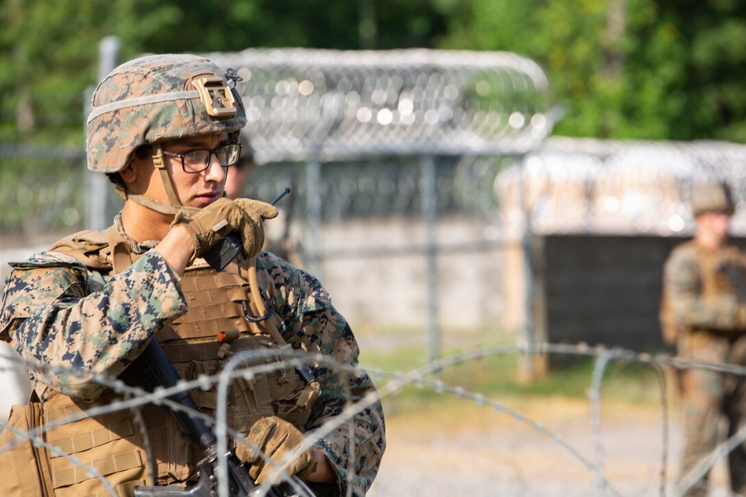 U.S. Marine Corps Lance Cpl. Cameron Gonzales, with Charlie Company, 3rd Platoon, Marine Corps Security Forces, U.S. Marine Corps Forces Command, Fleet Marine Force Atlantic, conducts a radio check during a Mission Readiness Exercise (MRX) July 21, 2020, on Fort A. P. Hill in Port Royal, Virginia. Radio checks are done to ensure that the company maintains a proper flow of communication. Fleet Antiterrorism Security Team (FAST) platoons execute MRX exercises prior to deployment to evaluate the platoons’ proficiency in core mission essential tasks.(U.S. Marine Corps Photo by Sgt. Desmond Martin/Released)