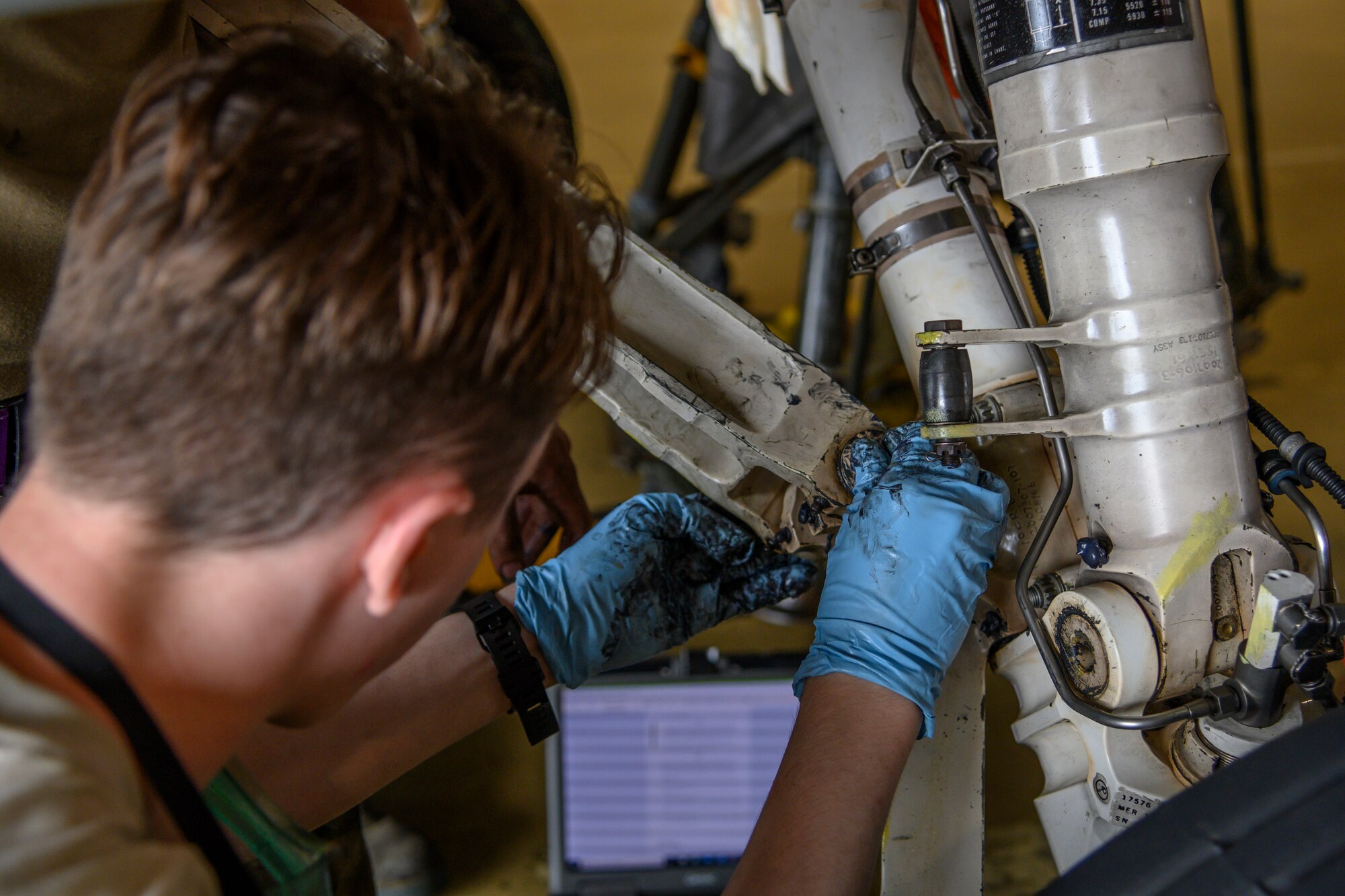 U.S. Air Force Senior Airman Dylan Smith, a 35th Maintenance Squadron Phase Inspection section journeyman, installs a drag brace at Misawa Air Base, Japan, July 22, 2020. The phase dock will normally handle 24 to 26 aircraft each fiscal year. This year 22 phase inspections have already been completed with two aircraft currently in the process of being double docked, or inspected simultaneously. (U.S. Air Force photo by Airman 1st Class China M. Shock)