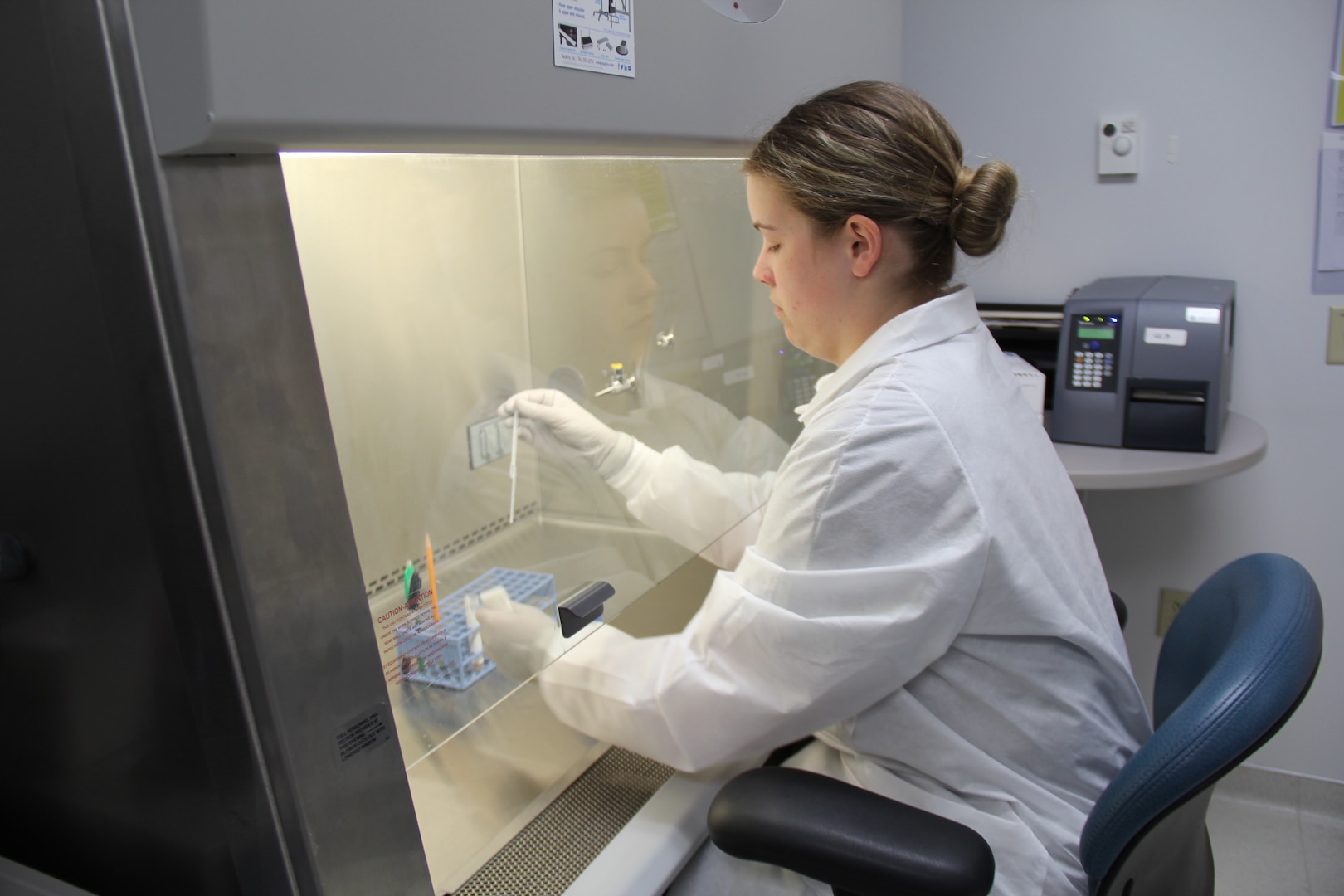 Spc. Gabrielle Gavlick, a microbiology specialist at Bassett Army Community Hospital prepares a sample for COVID-19 rapid testing though a biological safety cabinet. Bassett ACH became the first healthcare facility in interior Alaska to have the capabilities to perform COVID-19 testing.
