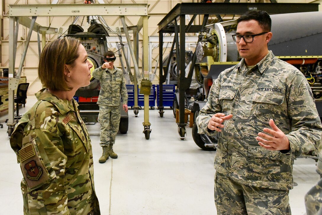 airmen talking in a hangar bay