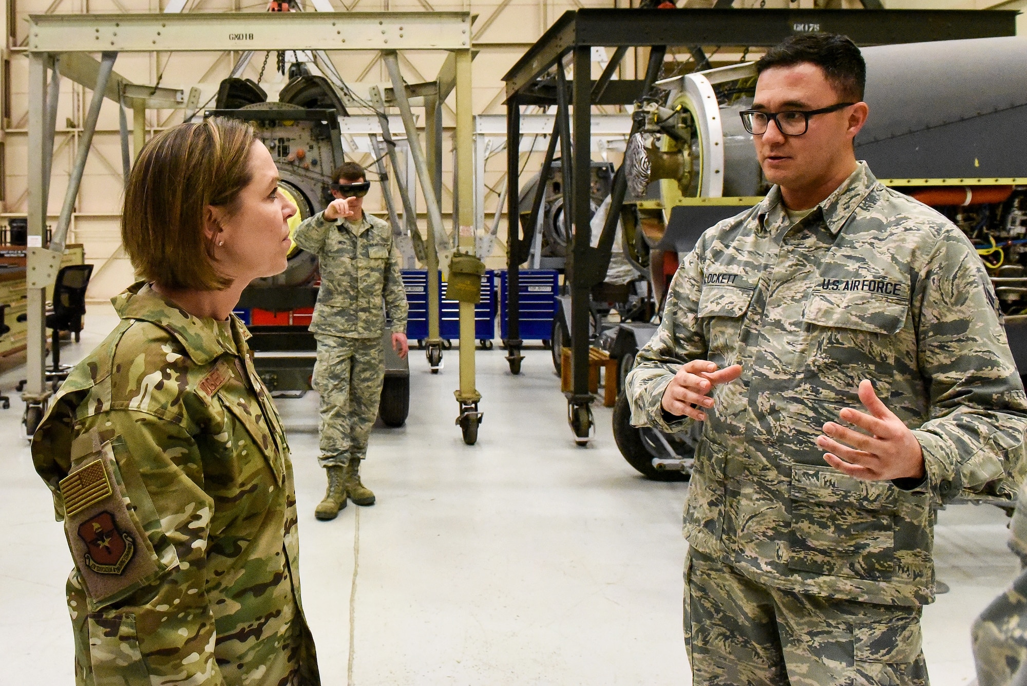 airmen talking in a hangar bay