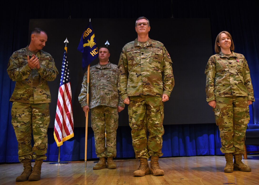 Colonel Michael Fae, 51st Medical Group commander, presents the new commander of the 51st Healthcare Operations Squadron, Lt. Col. Jimmy Scott, during the change of command and redesignation ceremony for the 51st Medical Operations Squadron at Osan Air Base, Republic of Korea, July 27, 2020. The 51st MDOS officially redesignated at the 51st HCOS, which will prioritize the care and treatment for dependents and retirees, and the 51st Aerospace Medicine Squadron will be replaced with the 51st Operational Medical Readiness Squadron, providing care for all active-duty members. (U.S. Air Force photo by Senior Airman Denise Jenson)
