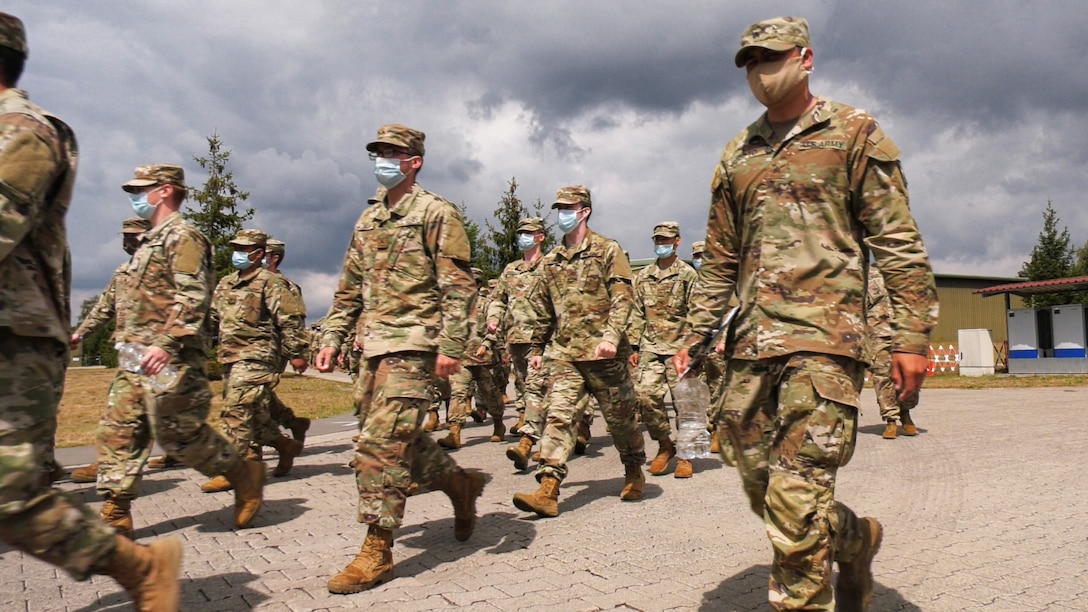 Soldiers, inbound from the United States to Europe, march to lunch at the Deployment Processing Center on Rhine Ordnance Barracks in Kaiserslautern, Germany July 17, 2020. The DPC currently houses incoming personnel from the United States undergoing quarantine and in-processing to the European theater. Task Force Wilkommen is a group of organizations facilitating this process during the COVID-19 pandemic. (U.S. Army Reserve photo by Staff Sgt. Chris Jackson/Released)