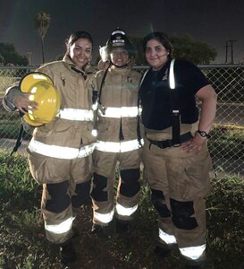 U.S. Army Spc. Maritssa Quintanilla (left), a combat medic specialist poses for a photo with fellow volunteers.