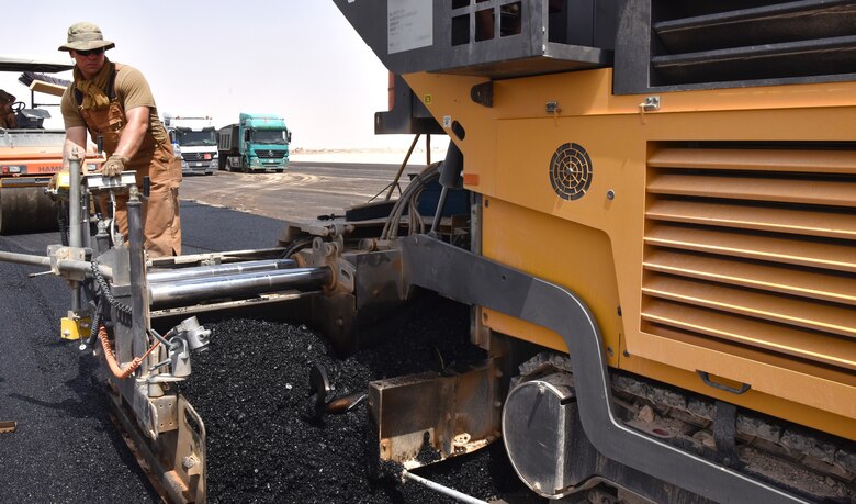 Airmen from the 378th Expeditionary Civil Engineer Squadron Dirt Boys shop work to finish construction on the new helicopter pad at Prince Sultan Air Base, Kingdom of Saudi Arabia.