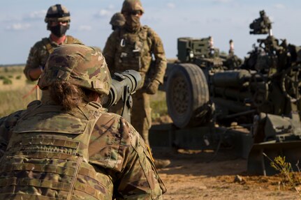 A U.S. Army Soldier assigned to Bravo Battery, 1st Battalion, 119th Field Artillery Regiment, Michigan Army National Guard, uses a collimator sight to ensure a M777 155mm howitzer is on target before firing the gun in a direct fire training exercise during Northern Strike 20, Camp Grayling, Michigan, July 25, 2020.