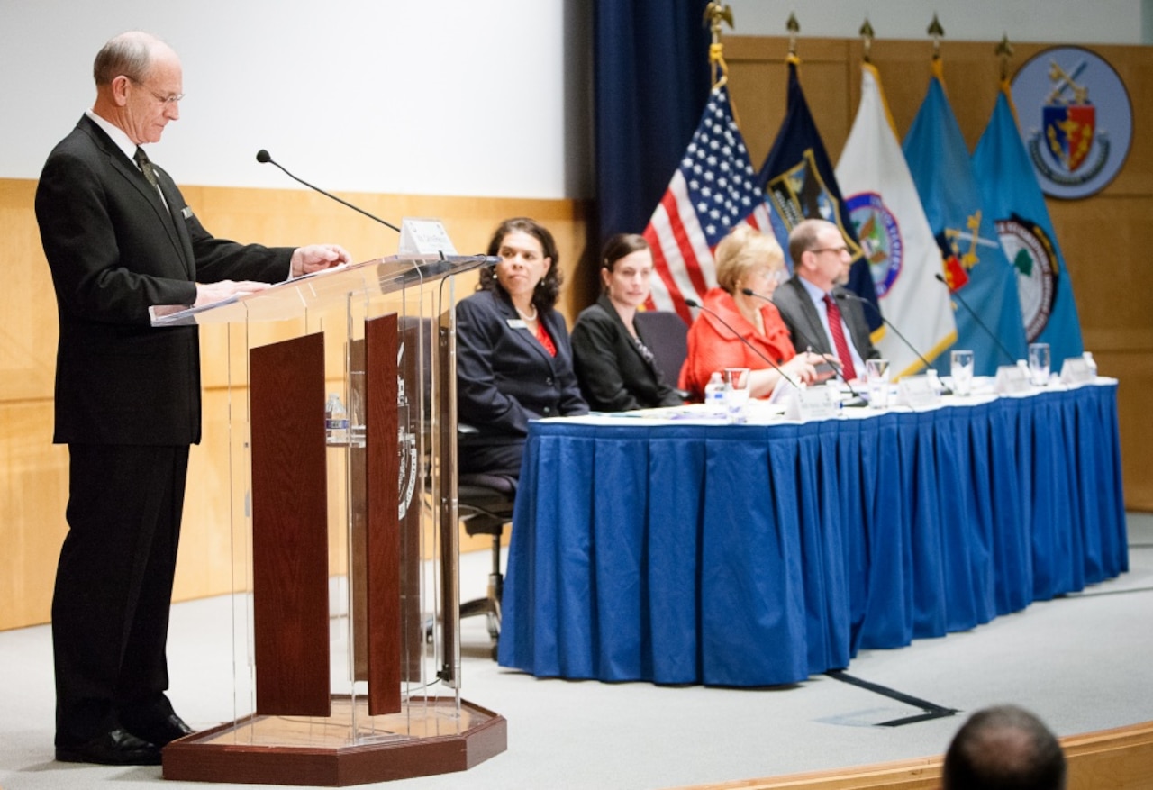 A man speaks from a podium.