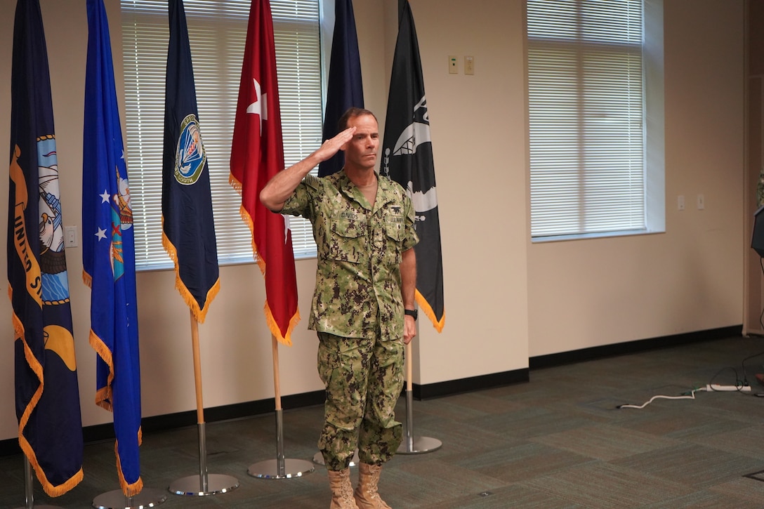 Rear Adm. Keith B. Davids salutes.