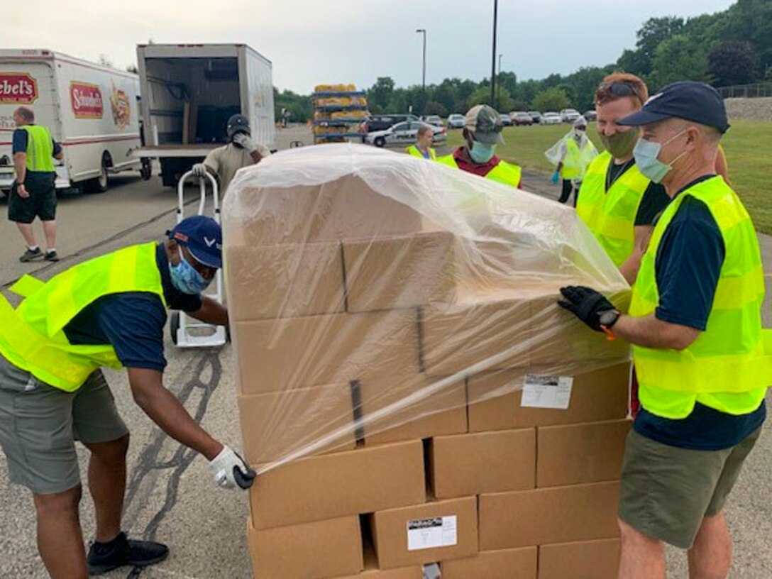 Reserve Citizen Airmen, assigned to the 910th Logistic Readiness Squadron, load food into vehicles on July 7, 2020, at Hickory Highschool in Hermitage, Pennsylvania. The Airmen volunteered their time to support the Community Food Warehouse of Mercer County food drive that serviced approximately 238 vehicles.