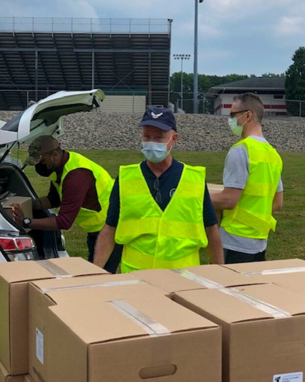Reserve Citizen Airmen, assigned to the 910th Logistic Readiness Squadron, load food into vehicles on July 7, 2020, at Hickory Highschool in Hermitage, Pennsylvania. The Airmen volunteered their time to support the Community Food Warehouse of Mercer County food drive that serviced approximately 238 vehicles.