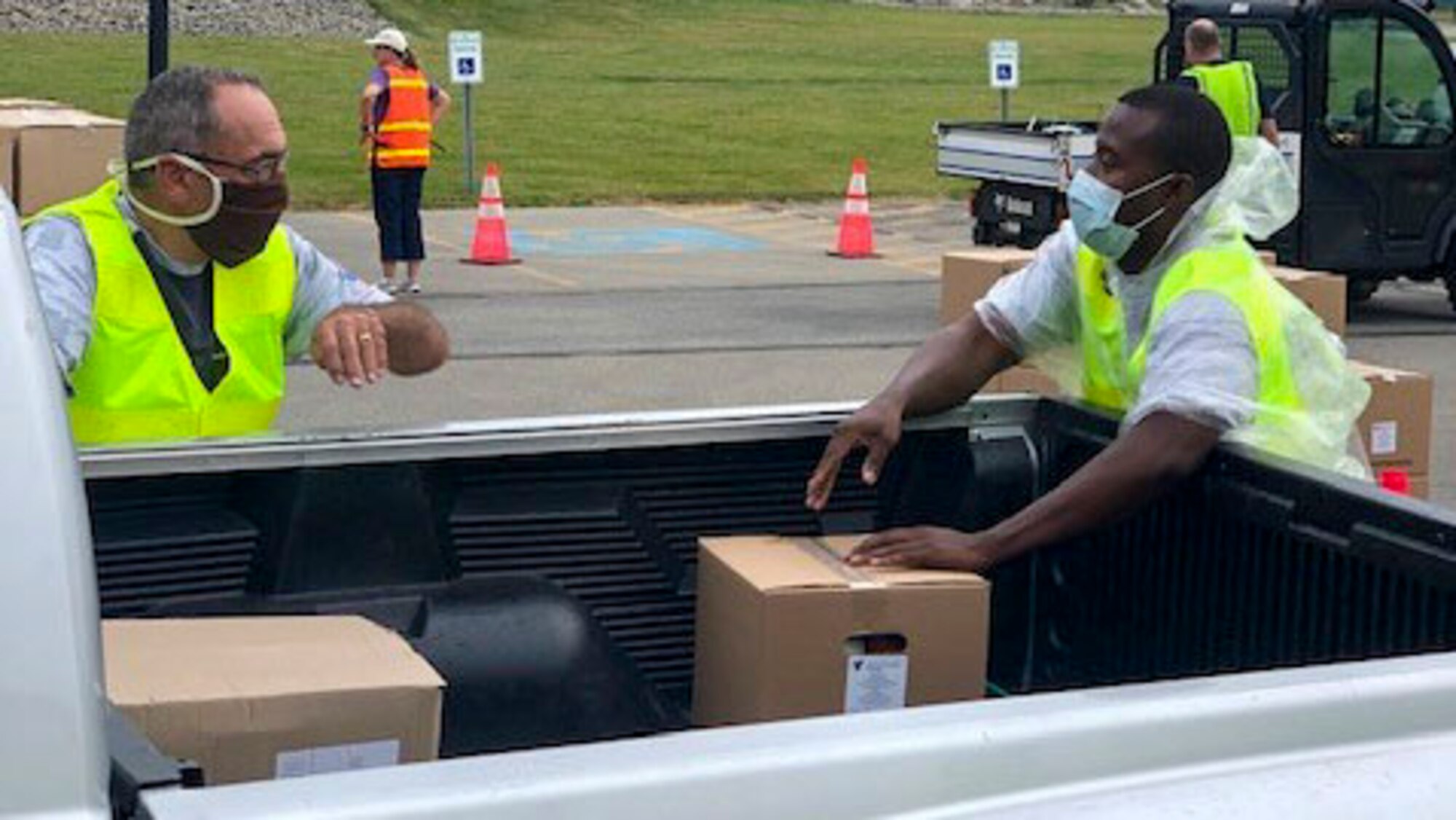 Reserve Citizen Airmen, assigned to the 910th Logistic Readiness Squadron, load food into vehicles on July 7, 2020, at Hickory Highschool in Hermitage, Pennsylvania. The Airmen volunteered their time to support the Community Food Warehouse of Mercer County food drive that serviced approximately 238 vehicles.