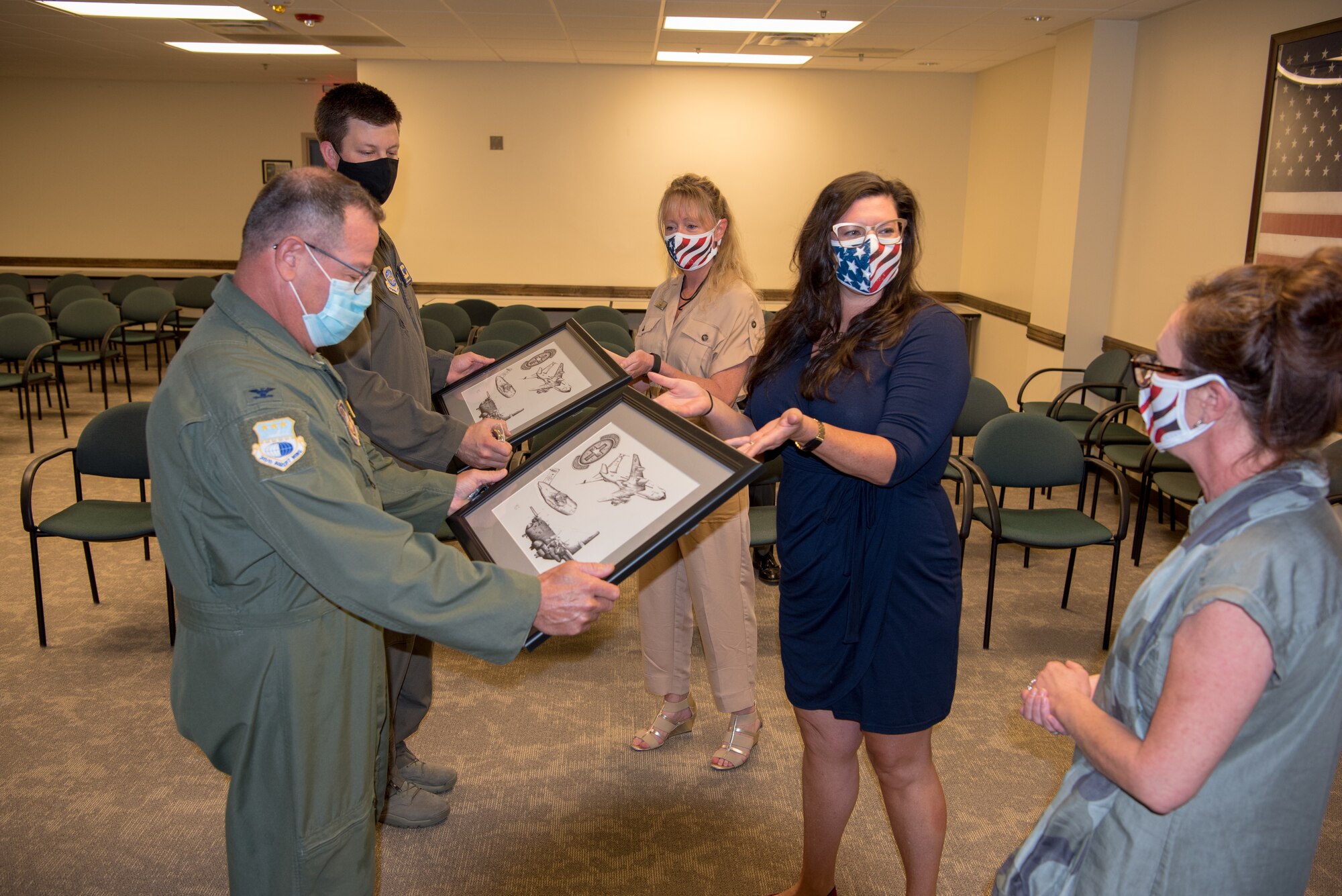 Col. Adam Willis, 315th Airlift Wing Commander, Joint Base Charleston, South Carolina and Col. Clint ZumBrunnen, 437th Airlift Wing Commander, Joint Base Charleston, are presented artwork from local honorary commanders at Joint Base Charleston on July 17, 2020. The hand drawn artwork was completed by Senior Airman Mike Liu, aeromedical evacuation technician, 433rd Airlift Wing, Joint Base San Antonio-Lackland, Texas.