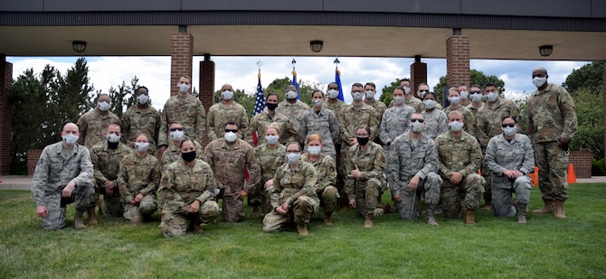 PETERSON AIR FORCE BASE, Colo. – Master sergeant selects assemble for a group photo at The Hub on Peterson Air Force Base, July 24, 2020. To account for the ongoing COVID-19 situation across the country, these Airmen were given cloth face masks with their new rank as a commemorative token. (U.S. Air Force photo by Griffin Swartzell)