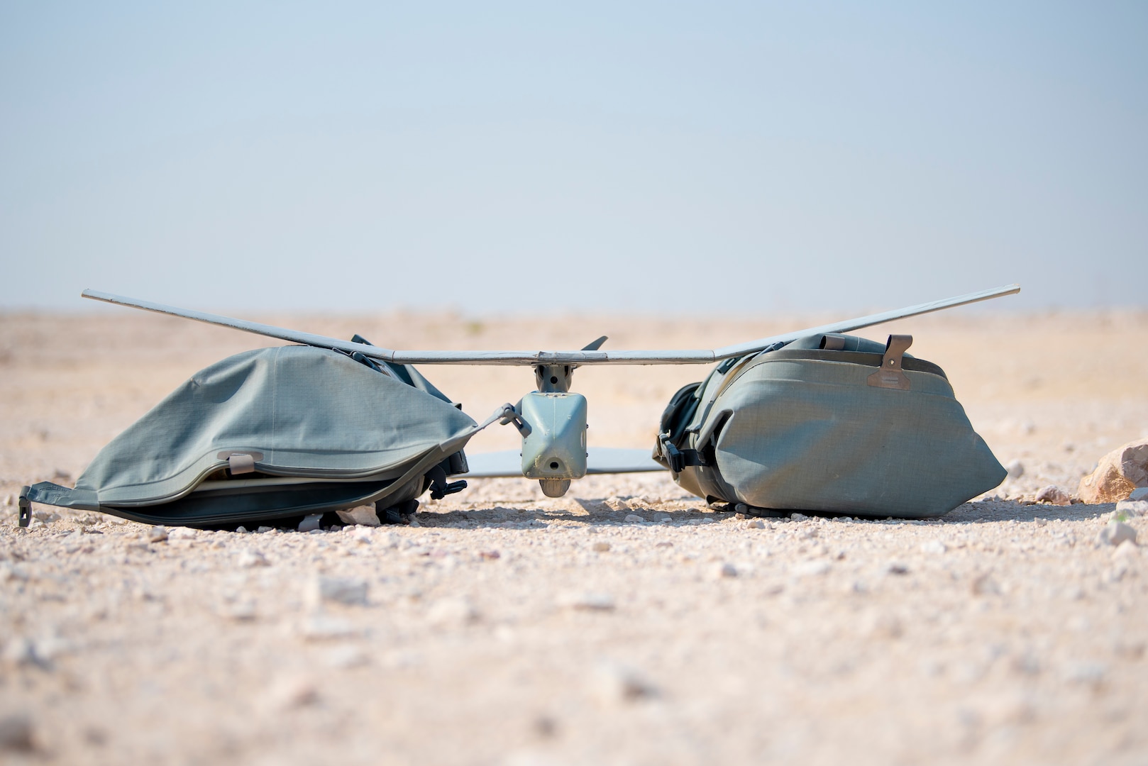A Raven B Small Unmanned Aircraft System is preparing for flight training at Al Udeid Air Base, Qatar, July 9, 2020. The Raven B is a drone with full-spectrum capability that can be hand-launched from nearly anywhere on the installation at any time. Its primary mission at AUAB is force protection, however, the drone has been flown for real-world missions to include conducting airfield assessments and post-storm damage analysis. (U.S. Air Force photo by Senior Airman Ashley Perdue)
