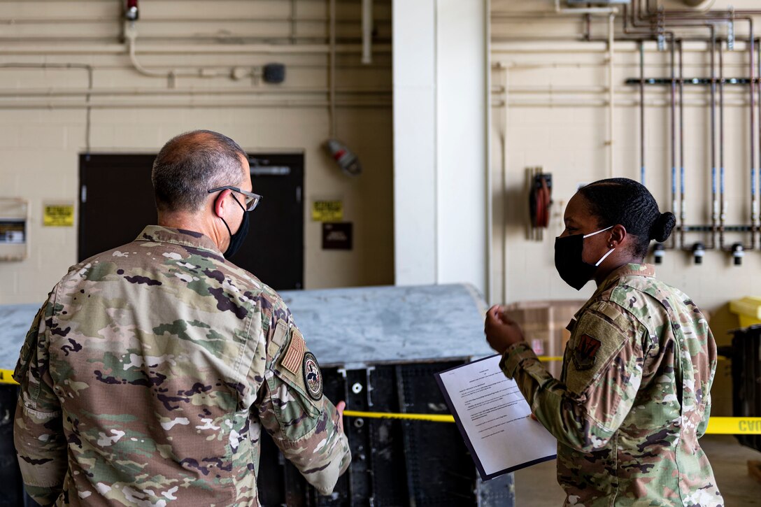 Photo of an Airman briefing the LATT director.