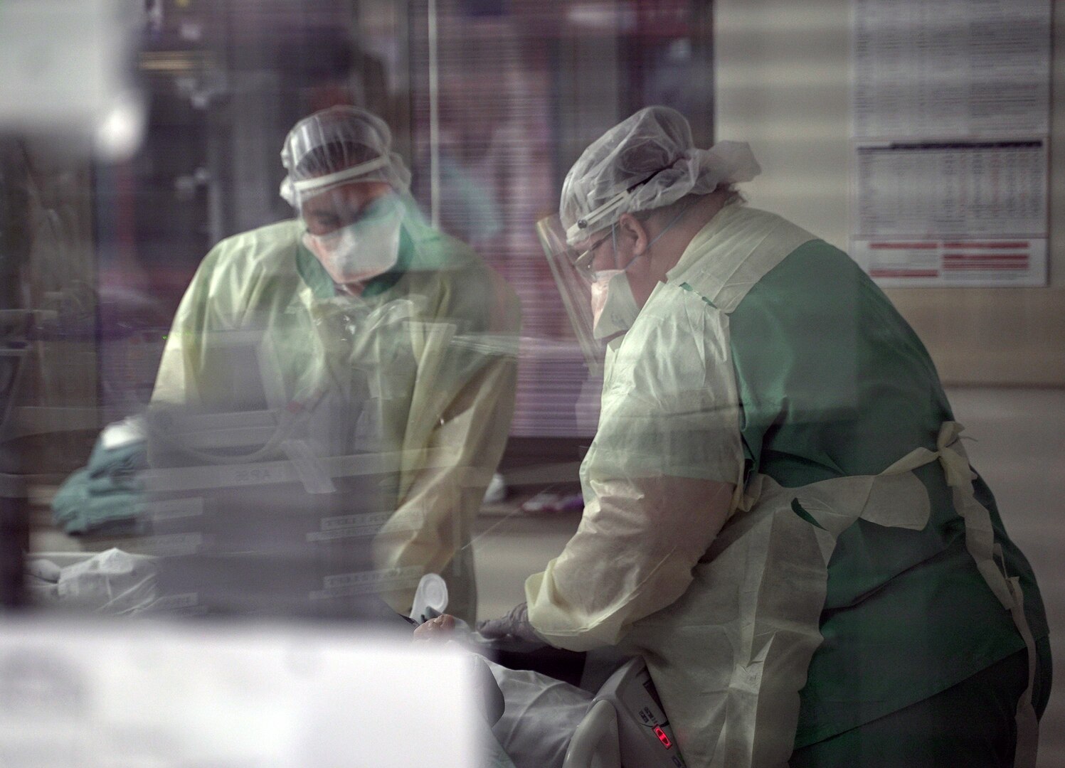 Brooke Army Medical Center nurses tend to a patient in a COVID-19 intensive care unit July 17.