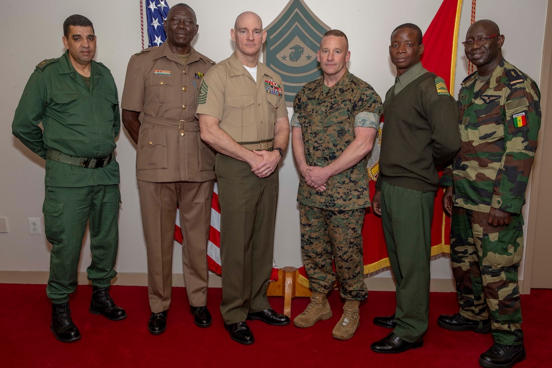 The 19th Sergeant Major of the Marine Corps, Sgt. Maj. Troy E. Black stands for a photo with U.S. Marine Africa Command Sergeant Major, Sgt. Maj. Richard Thresher and representatives from Kenya, Morocco, Senegal and Mozambique for a Key Leader Engagement at the Office of the Sergeant Major of the Marine Corps, Arlington, Va., Mar. 13, 2020. The African leaders and their translators met with Sgt. Maj. Black to exchange leadership tactics, particularly in regard to Professional Military Education, talent development, and health and fitness. (U.S. Marine Corps photo by Sgt. Victoria Ross)