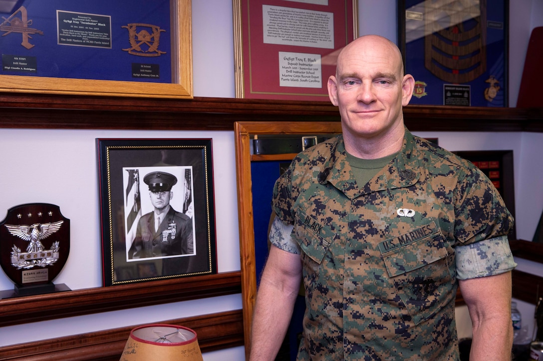 The 19th Sergeant Major of the Marine Corps, Sgt. Maj. Troy E. Black poses for a photo with a photo of the 8th Sergeant Major of the Marine Corps, Sgt. Maj. John R. Massaro (retired) in Arlington, V.A., May 21, 2020. The office of the Sergeant Major of the Marine Corps recognized Sgt. Maj. Massaro as the oldest living Sergeant Major of the Marine Corps and as the gentleman who coined the term "Ohrah". (U.S. Marine Corps photo by Sgt. Victoria Ross)