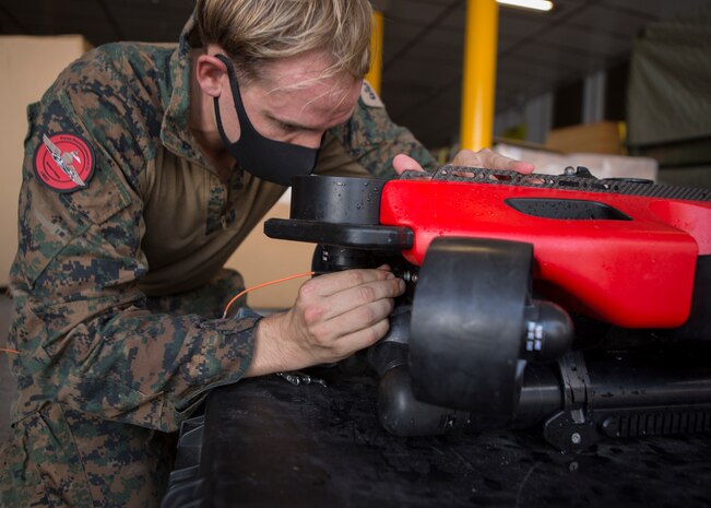 A U.S. Marine removes a Strategic Robotics System Fusion Underwater Unmanned Vehicle out of the water during Littoral Explosive Ordnance Neutralization operations aboard the expeditionary fast transport ship USNS City of Bismarck (EPF 9) at sea, July 15.