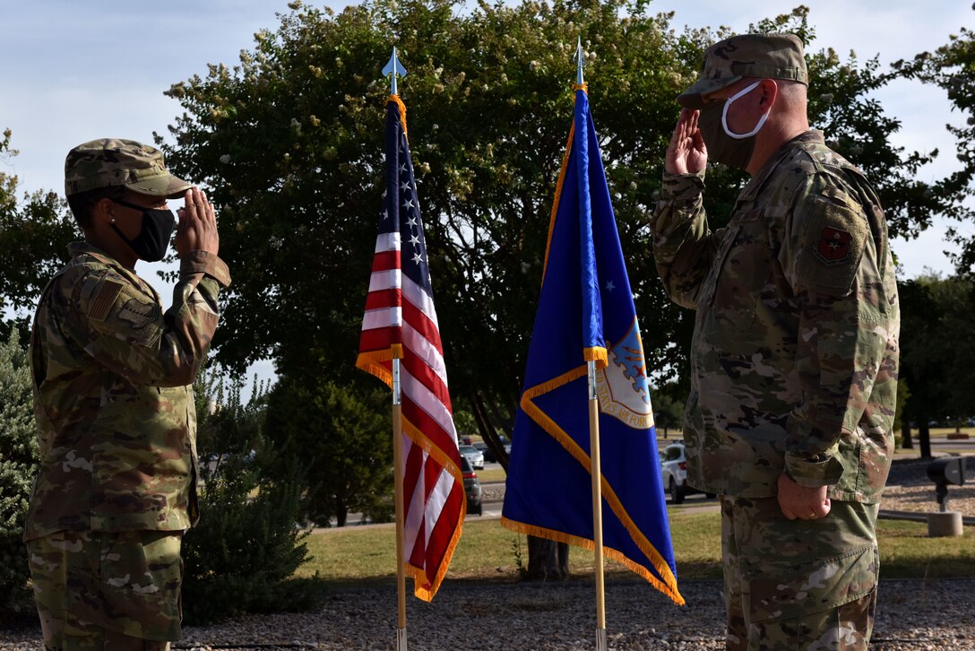 U.S. Air Force Lt. Col. Warren Conrow, 17th Healthcare Operations Squadron outgoing commander, salutes Col. Lauren Byrd, 17th Medical Group commander, relinquishing command at the 17th HCOS change of command ceremony in front of the Norma Brown Building on Goodfellow Air Force Base, Texas, July 27, 2020. The change of command ceremony is a time honored military tradition that signifies the orderly transfer of authority. (U.S. Air Force photo by Senior Airman Seraiah Wolf)