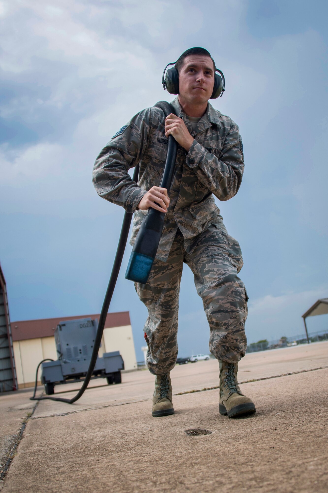 Staff Sgt. Wayne Russell pulls a power cable from a generator