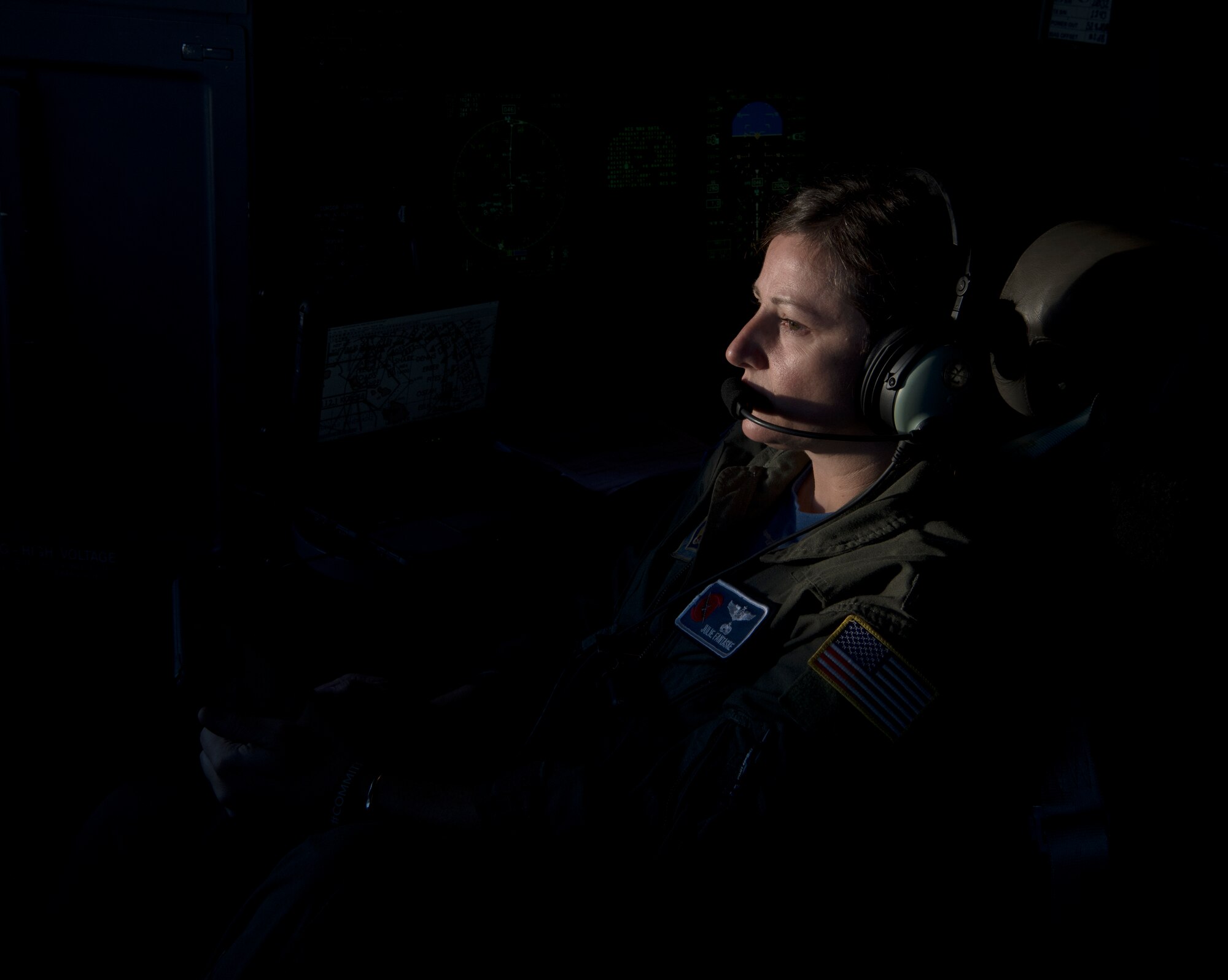 Capt. Julie Fantaske, navigator for the 53rd Weather Reconnaissance Squadron at Keesler Air Force Base Miss., looks on as her pilot crew members steer through Hurricane Douglas from Barbers Point Kapolei, Hawaii, July 26, 2020. The 53rd WRS is part of the Air Force Reserve 403rd Wing and is the only unit of its kind in the entire Department of Defense. (U.S. Air Force Photo by Senior Airman Kristen Pittman)