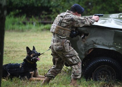 Staff Sgt. Matthew Ratchford, 316th Security Support Squadron Military Working Dog section handler, shoots at targets as part of a competition at Joint Base Andrews, Md., July 24, 2020.