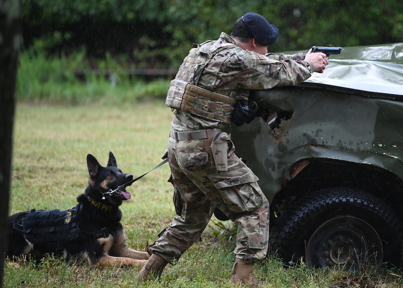 Staff Sgt. Matthew Ratchford, 316th Security Support Squadron Military Working Dog section handler, shoots at targets as part of a competition at Joint Base Andrews, Md., July 24, 2020.