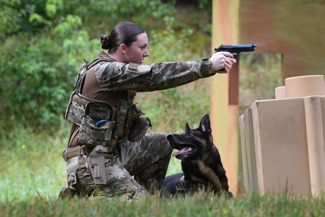 Staff Sgt. Samantha Frydenlund, 316th Security Support Squadron Military Working Dog section handler, aims at a target as part of a “Top Dog” competition at Joint Base Andrews, Md., July 24, 2020.