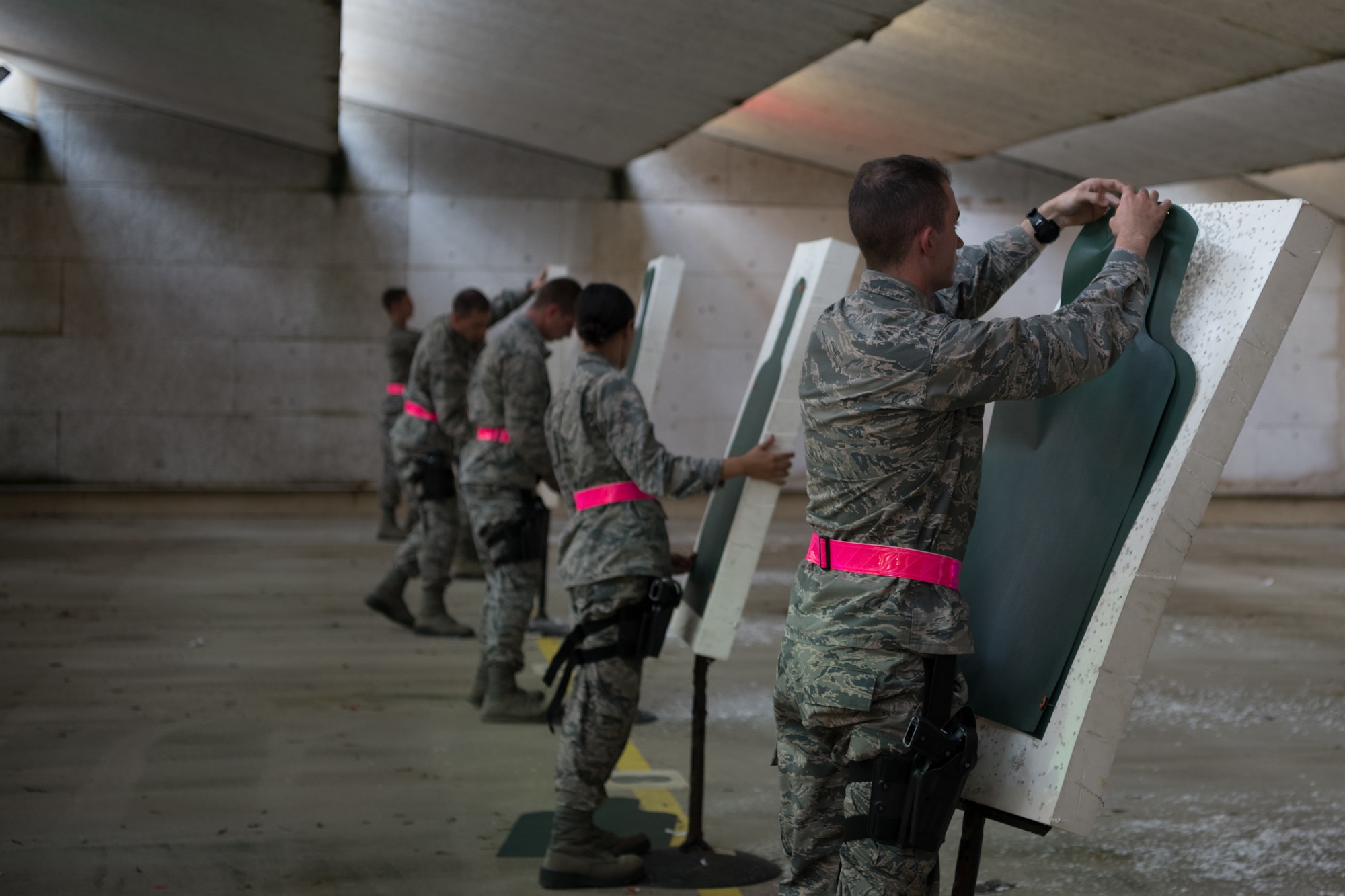 Air Force Reserve Officer Training Corps cadets retrieve their paper targets and replace them with new paper targets after completing their weapons qualification July 9, 2020, at the Combat Arms Training and Maintenance range on Maxwell Air Force Base, Alabama.