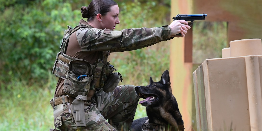 Staff Sgt. Samantha Frydenlund, 316th Security Support Squadron Military Working Dog section handler, aims at a target as part of a “Top Dog” competition at Joint Base Andrews, Md., July 24, 2020.