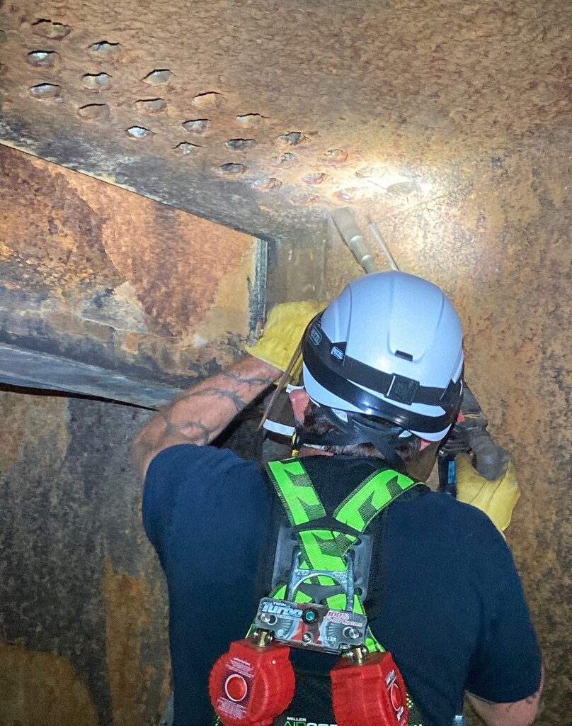 John Martin maintenance staff remove mineral and debris buildup from conduit air vents, June 2020.