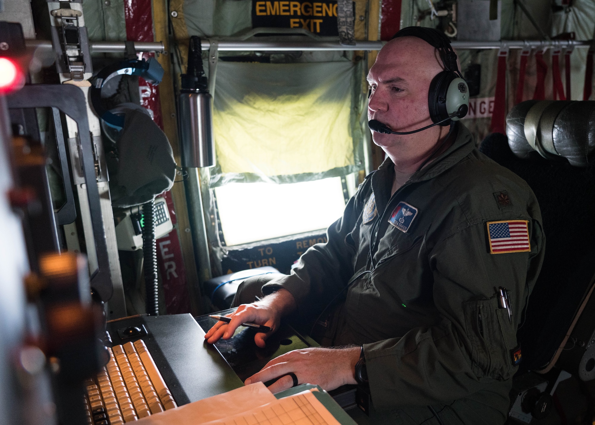 Maj. Tobi Baker, 53rd Weather Reconnaissance Squadron aerial reconnaissance weather officer, reviews weather data collected while flying in Hurricane Douglas July 26, 2020. The Air Force Reserve Hurricane Hunter aircrew flew into the first hurricane of the Pacific season to collect weather data to assist the Central Pacific Hurricane Center with their forecasts. The 53rd WRS, assigned to the 403rd Wing at Keesler Air Force Base, Mississippi, departed July 22 to conduct operations out of Barbers Point Kapolie Airport, Hawaii. (U.S. Air Force photo by Lt. Col. Marnee A.C. Losurdo)
