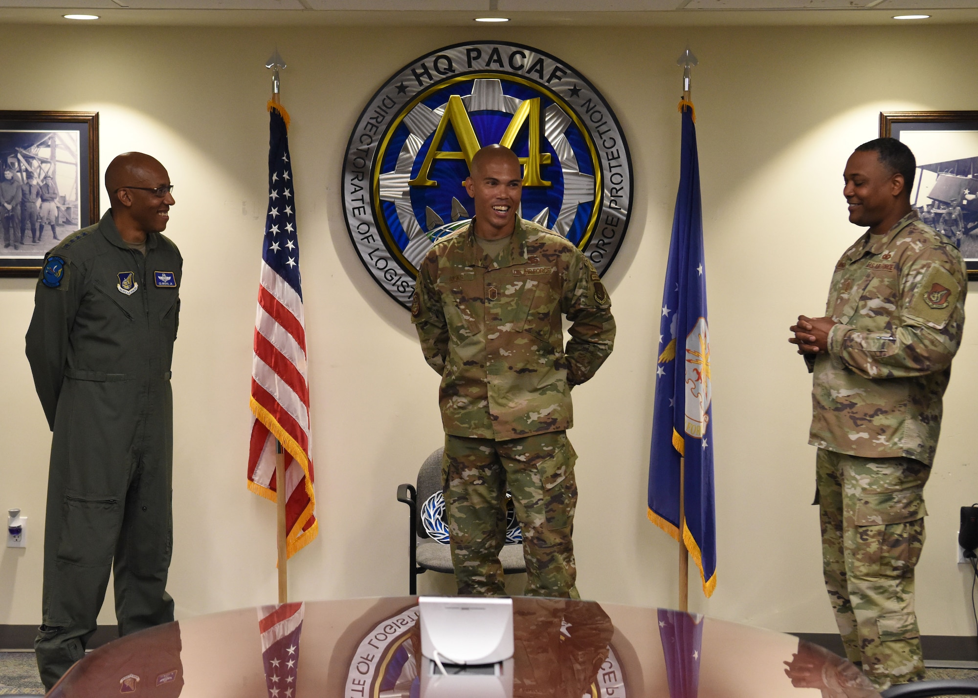 Gen. CQ Brown, Jr., former Pacific Air Forces commander and Chief Master Sgt. Anthony Johnson, PACAF Command Chief congratulate Senior Master Sgt. Christopher Ricks, PACAF/A4 Security Forces Operations superintendent, as PACAF’s 2020 Outstanding Airmen of Year, Joint Base Pearl Harbor-Hickam, Hawaii, June 18.