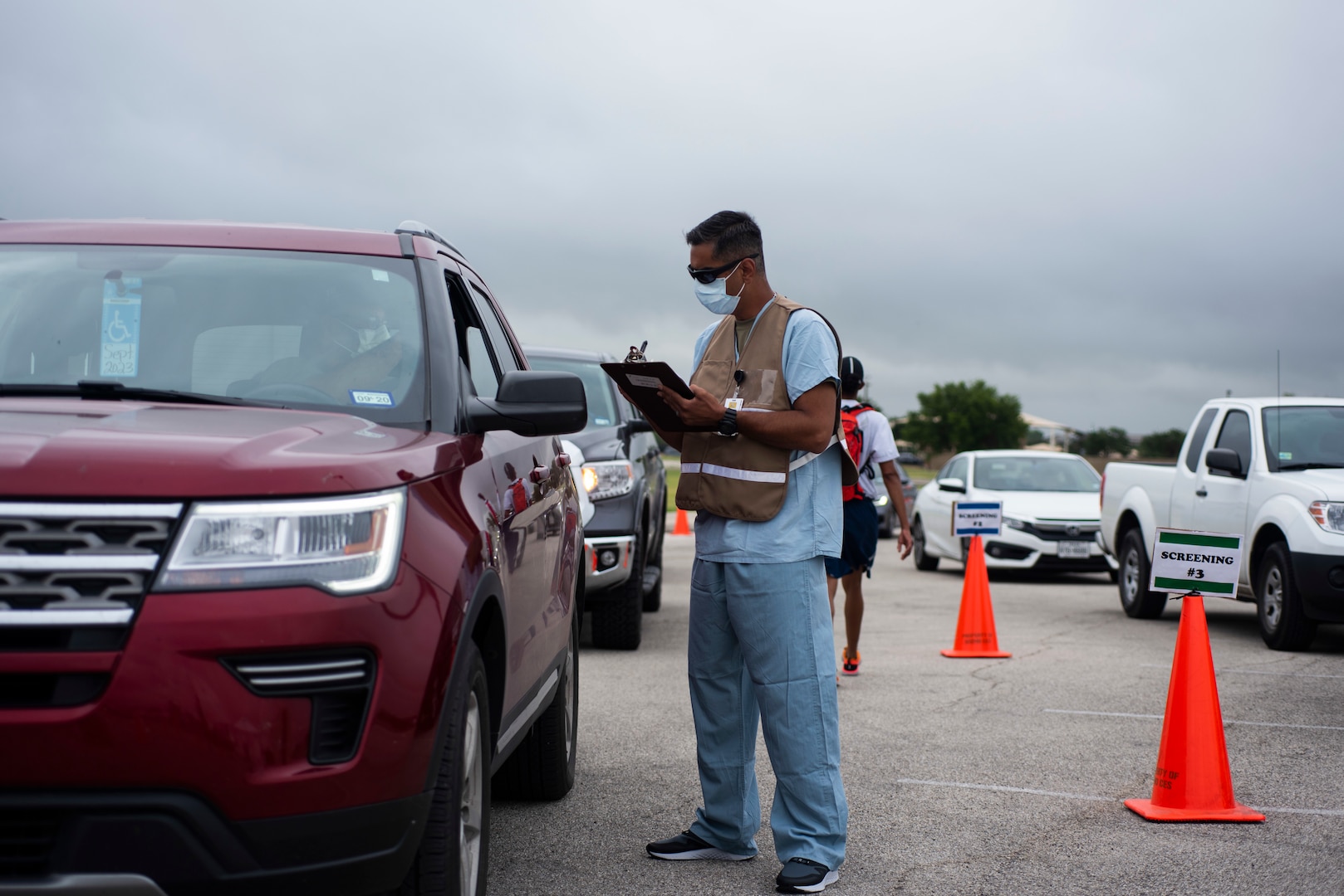 Members of the 59th Medical Wing man a drive through COVID-19 screening clinic on Lackland Air Force Base, June 26, 2020. The drive through clinic was reestablished as part of the protective measures implented as Joint Base San Antonio returns to HPCON Charlie. (U.S. Air Force photo by SSgt Zachary Bumpus)