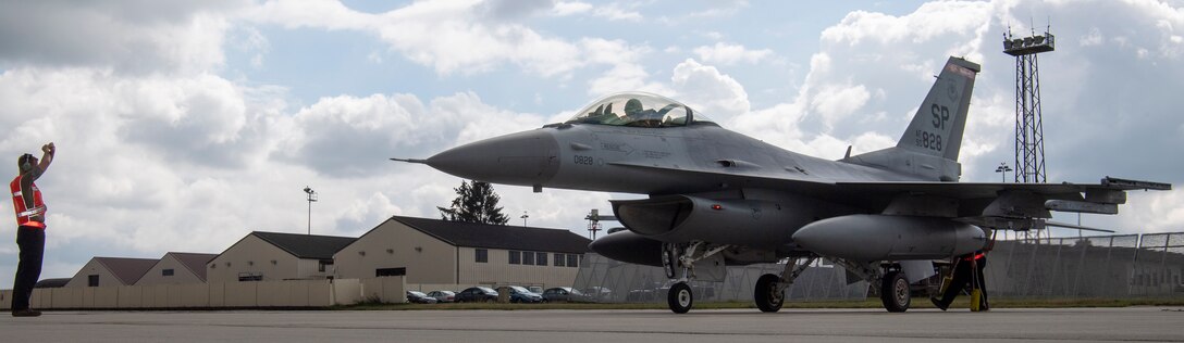 Military aircraft and Airmen on the flight line