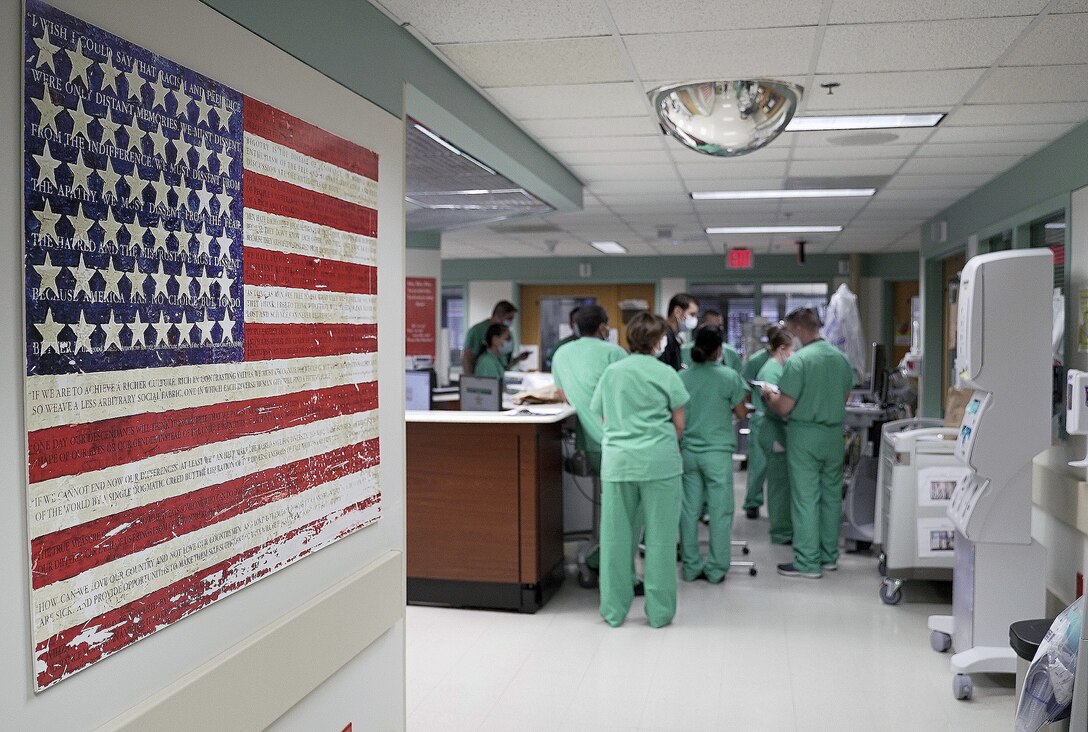 Brooke Army Medical Center nurses conduct a shift change briefing in a COVID-19 intensive care unit July 17.